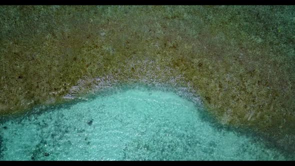 Aerial flying over sky of marine seashore beach trip by turquoise lagoon and white sand background o