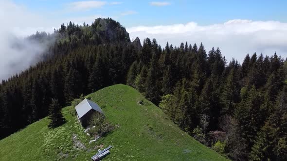 Drone Shot of Mountain Passage with a Small House, Forest and Cloud bed