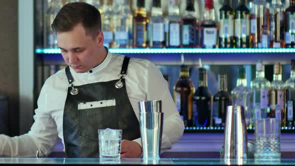 Expert Barman Is Making Cocktail at Night Club