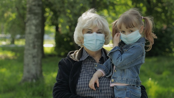 Grandmother with Granddaughter Takes Off Masks After Coronavirus Quarantine End