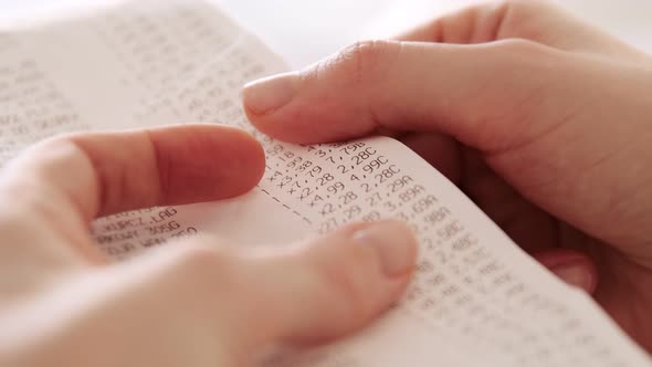 Hands checking grocery receipt or bill after grocery shopping