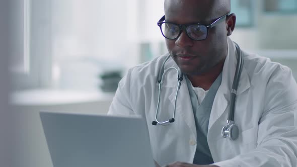 African American Physician Working On Laptop