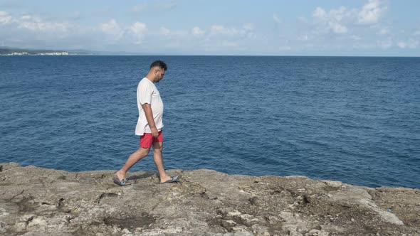 Man Walking Near Sea