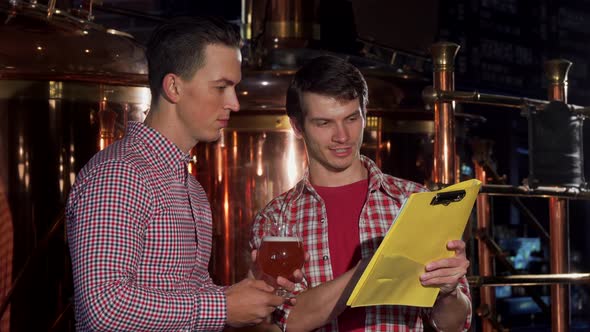 Two Brewers Examining Craft Beer, Working at the Brewery