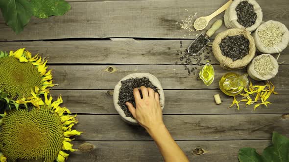 Sunflower Oil and Seeds on an Old Wooden Table. Flat Lay.