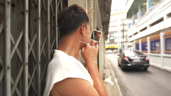 4K Confidence Asian lgbtq guy wearing woman clothes walking down city street.