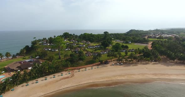 Closing in aerial shot of a beach resort beach and villas in Mermaids Bay in Southwest Ivory Coast S