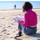 Dressed Girl Reading a Book Sitting on the Sand - VideoHive Item for Sale