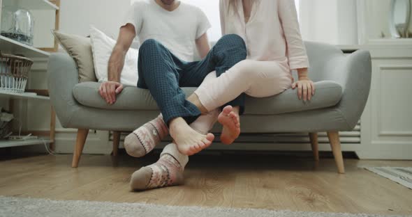 Young Couple Home Time Playing with Legs Spending