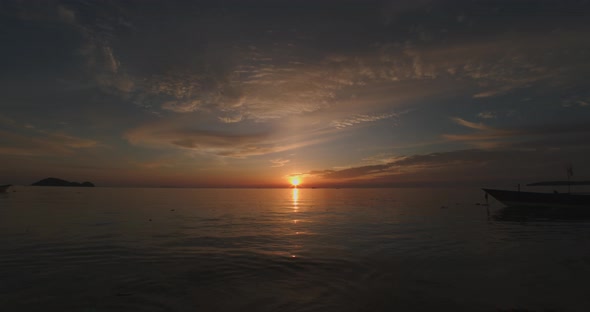 Sun goes down to the sea  with light reflection on water