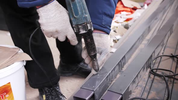 Rivet pistol in action, worker installing rivets