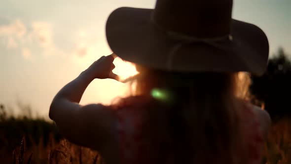 Girl Made Love Heart From Finger. Woman In Hat Enjoying Sun. Lady Making Heart Shape With Hands.