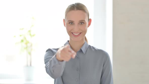 Portrait of Woman Pointing at the Camera and Inviting