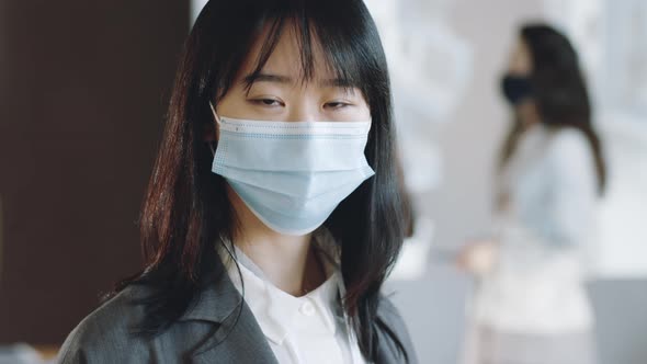 Portrait of Asian Businesswoman in Mask on Conference