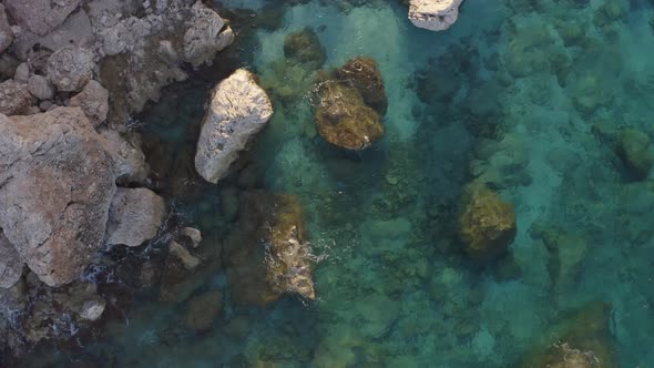 Aerial View of Rocky Shore with Turquoise Ocean Water