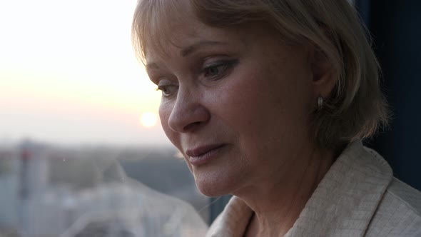 Human Grief Mature Sad Woman Looks Out Window From Apartment Hoping For Miracle