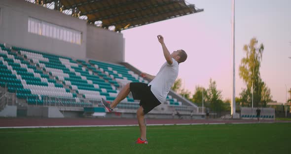 Soccer Player Kicking Ball in Jump. a Soccer Player in Dramatic Play During a Soccer Game 