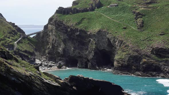 The ruins of  popular tourist destination Tintagel castle in Cornwall on top of a cliff with new bri