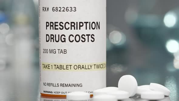 Prescription drug cost bottle and pills