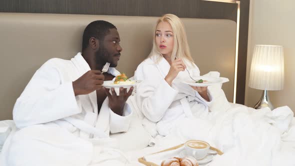 Adorable Multiethnic Couple Have Breakfast in Hotel
