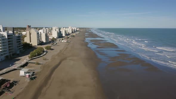 Aerial Drone view going up of empty beach with low tide, in Monte Hermoso, Argentina