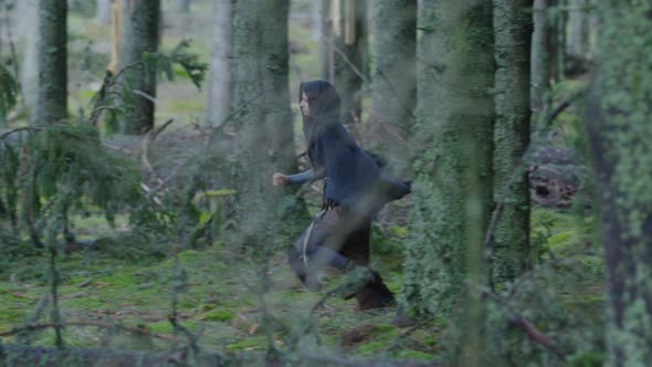 Young woman running through the forest