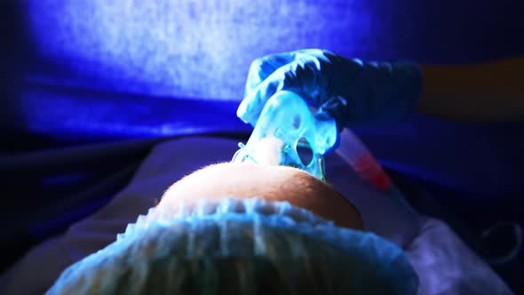 Hand of a doctor giving oxygen to a pregnant woman