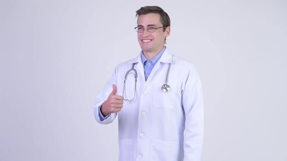 Young Happy Handsome Man Doctor Giving Thumbs Up
