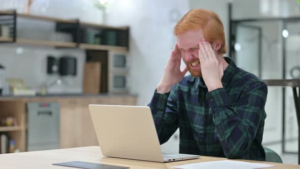 Beard Redhead Man with Headache Using Laptop in Cafe 