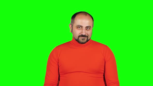 Puffy Guy Sitting and Proposes To Go with Him at Party. Green Screen. Slow Motion