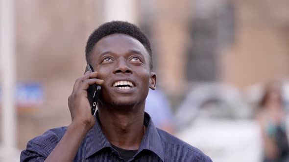 good news, happiness, joy - african american man smiling talking on the phone