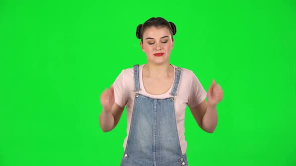 Girl Angry Covering Her Ears with Her Hands on Green Screen at Studio