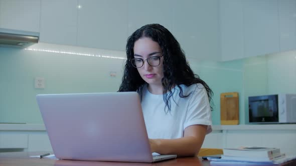 Woman Typing on Laptop Sitting on Sofa at Home, Businesswoman Sits at Home Types on Smartphone