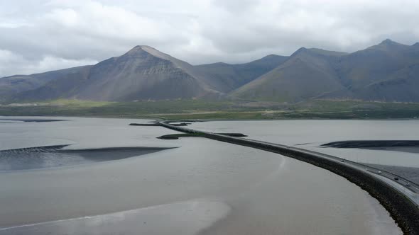 Aerial View Of Cars Driving On Asphalt Road Crossing Peninsula In Westfjords