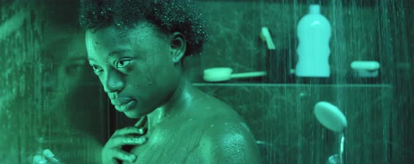 Pensive African American Woman in Shower Cabin
