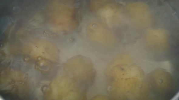 Potatoes Poured Into Pot Of Boiling Water