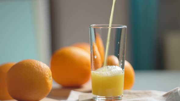 Orange Juice is Pouring Into the Glass