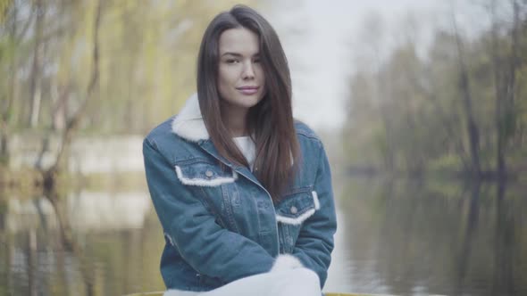 Portrait of Pretty Young Smiling Woman Looking in the Camera. Beautiful Landscape, River on