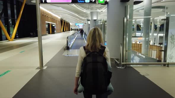Woman on Escalator at International Airport