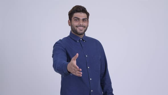 Happy Young Bearded Indian Businessman Giving Handshake