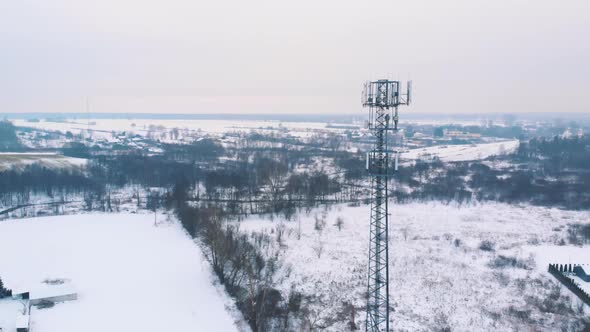 Beautiful Landscape Covered in Snow with 5g Tower Rising Above Fields