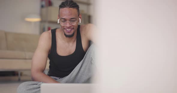 African American Fitness Trainer Using Laptop for Online Training with Client During Coronavirus