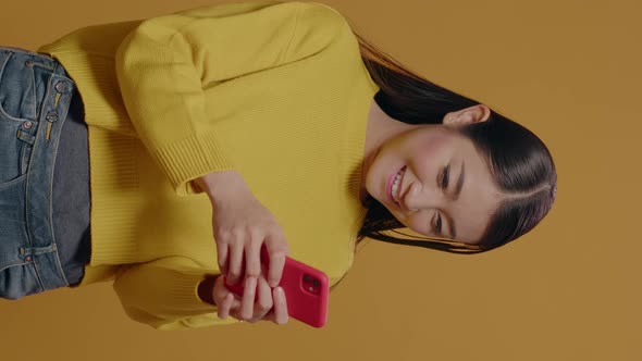 Vertical Video Smiling Person Using Smartphone and Typing Message