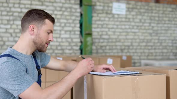 Delivery Man Writing Something to Clipboard