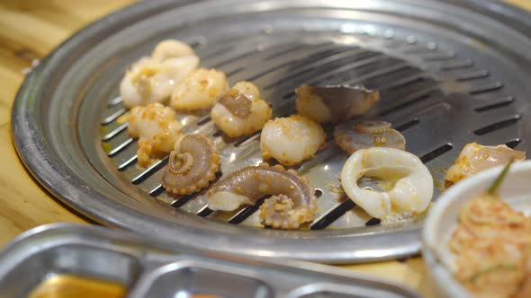 Family Visits a Korean Grill Restaurant Where You Can Cook Your Own Food. Travel To Korea Concept