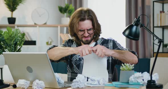 Office Worker in Glasses Sitting at His Workplace at Home, Working with Papers