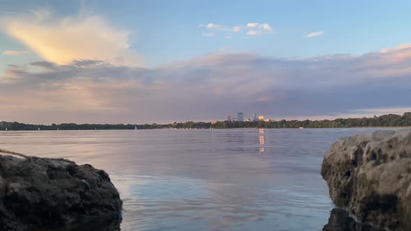 time lapse over lake in minneapolis, down town minneapolis seen in the distance