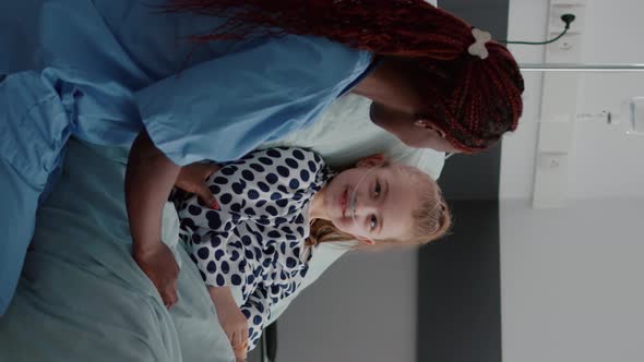 Vertical Video African American Practitioner Nurse Discussing Sickness Treatment with Little Patient