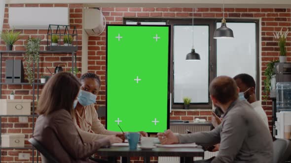 Team of Colleagues Working with Vertically Green Screen