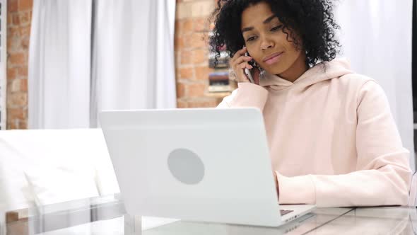 AfroAmerican Woman Talking on Phone Attending Phone Call